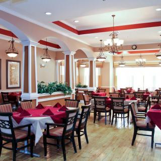 A spacious and elegantly designed dining area with tables set for service.