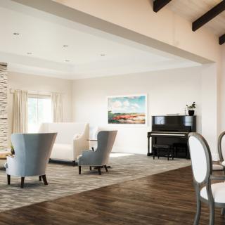 A spacious and elegantly designed living room featuring comfortable seating, a piano, and wall art, all accented by warm wood flooring and bright natural light.