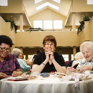 A group of senior women enjoying a social gathering indoors.