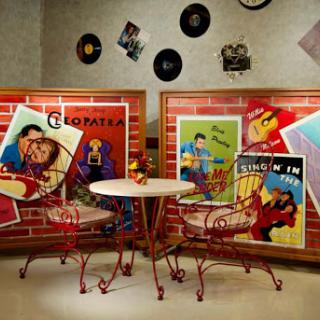 A cozy retro diner corner adorned with vibrant movie posters and classic music records, inviting you to enjoy a nostalgic ambiance.