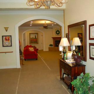 A warmly lit hallway with elegant furnishings and decor.