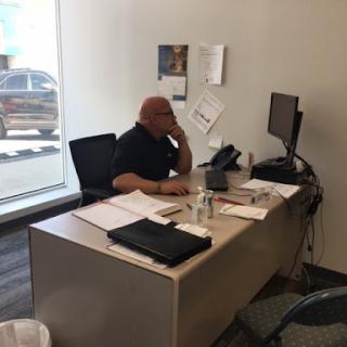 A person engaged in a phone call at their office desk.