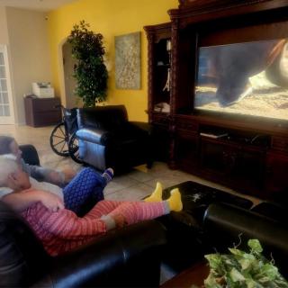 Children watching TV in a cozy living room setting.