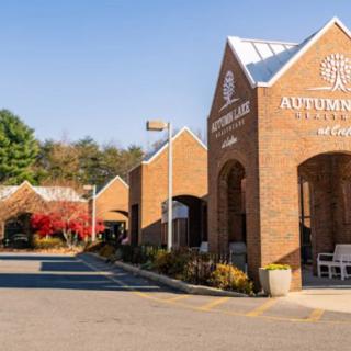 A brick medical center with a parking lot on a sunny day.