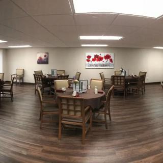 An empty dining area with neatly arranged tables and chairs.