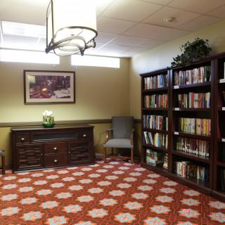 A cozy library corner with bookshelves and a comfortable reading chair.