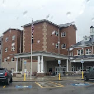 A hospital building captured in rainy weather.