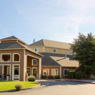 A hotel building with a landscaped exterior on a sunny day.