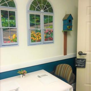 A cozy dining area with wall decorations and a small table.