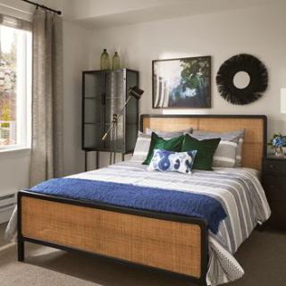 A cozy and well-decorated bedroom with a neatly made bed and stylish furnishings.