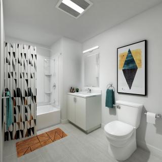 A modern, minimalist bathroom with a geometric shower curtain and artwork.