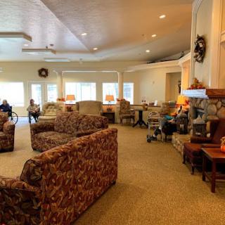 A cozy lounge area featuring armchairs, sofas, and soft lighting.