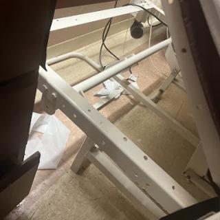 View of a bed frame and its support structure from beneath.