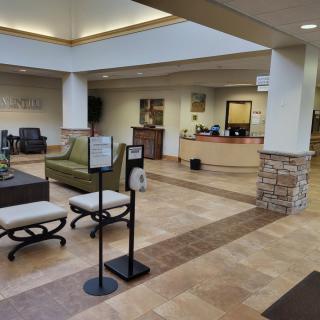A spacious and modern reception area with seating arrangements in a lobby.