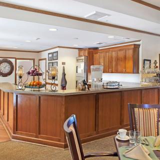 A cozy kitchen and dining area featuring wooden cabinets and elegant decor.