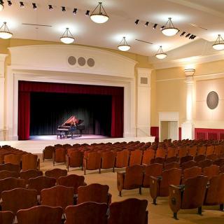 An empty theater auditorium with a stage and seating.