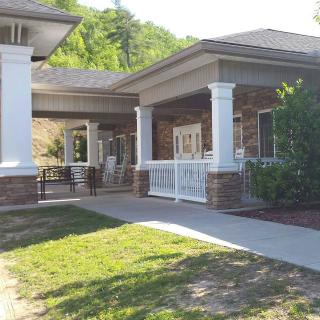 A building entrance with columns and a landscaped yard.