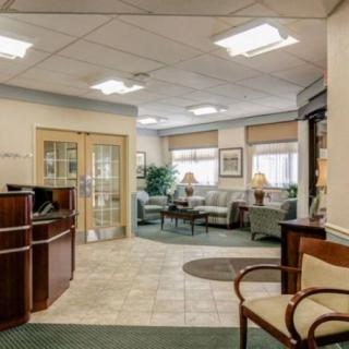 A cozy waiting room with comfortable seating and a reception desk.