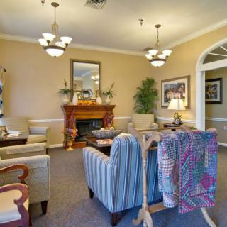 A cozy living room with elegant furnishings and a fireplace.