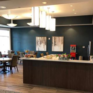 A modern lounge area featuring contemporary design elements, including stylish lighting and artwork.