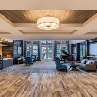 A spacious and elegant living room with modern furnishings, hardwood floors, and ample natural light.