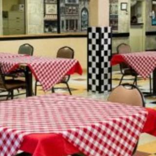 A cozy restaurant interior with checkered tablecloths on the tables.