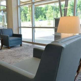 A modern lobby with comfortable seating and large windows providing natural light.