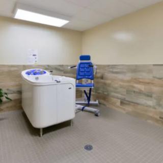 A therapy room equipped with specialized exercise equipment for physical rehabilitation.