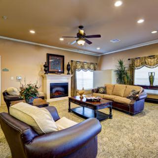 A cozy living room featuring comfortable seating, a stylish coffee table, and a warm fireplace.