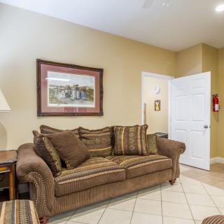 A cozy living room with a comfortable sofa and decorative painting.