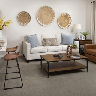 A modern living room with a white sofa, stylish coffee table, and decorative wall art.