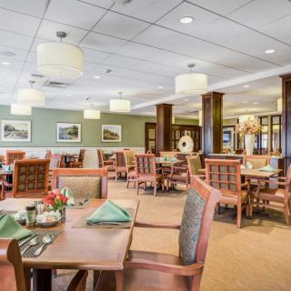 A well-lit, casual dining restaurant interior with neatly arranged tables and chairs.