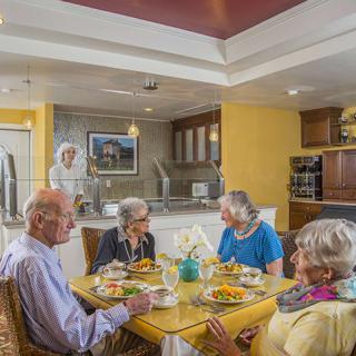 A group of seniors enjoying a meal together in a cozy dining area.