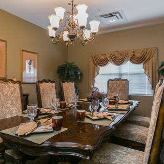 A beautifully decorated dining room with an elegant table setting and chandelier.