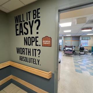 A motivational message on the wall of a healthcare facility, encouraging resilience and determination.