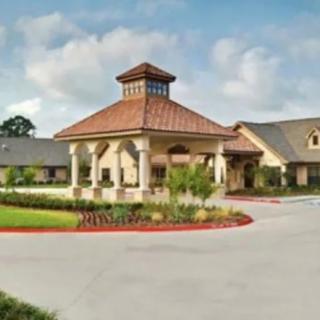 A well-maintained building with a prominent entrance and surrounding landscape.