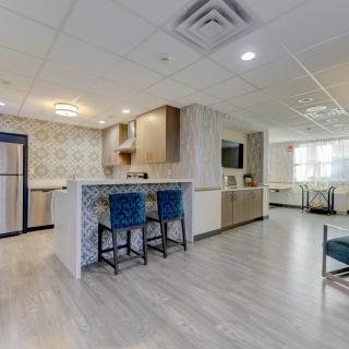 A modern open space kitchen with a breakfast bar and seating area.