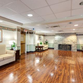 A spacious and modern lobby featuring comfortable seating, wooden floors, and stylish decor.
