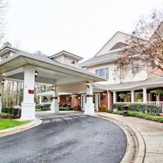 A welcoming entrance to a residential building with a covered driveway.