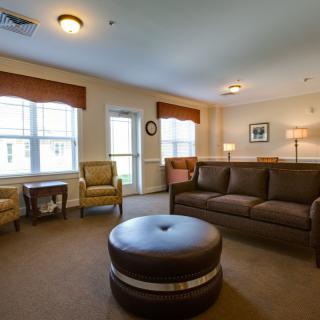 A cozy living room with a sofa, chairs, and soft lighting.