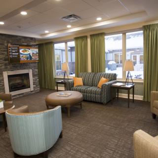 A cozy living room with modern decor featuring a fireplace and comfortable seating.