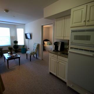 A cozy apartment with a view of the living area and kitchen.