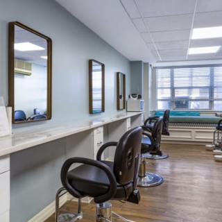 Modern hair salon interior with mirrors and styling chairs.