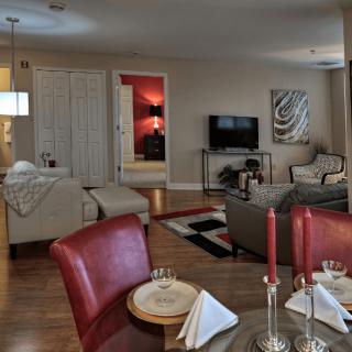 A modern living room featuring a comfortable seating area with a sofa, a television, and an adjacent dining space.