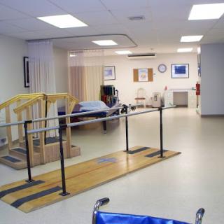 A rehabilitation therapy room equipped with walking bars and patient care facilities.