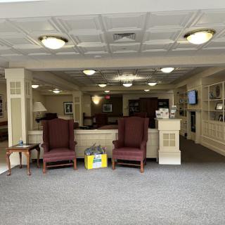 A cozy lobby area featuring comfortable chairs and warm lighting.