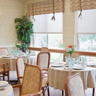 An elegantly decorated restaurant dining room with neatly arranged tables and chairs.