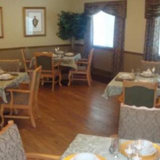A cozy dining room setup with neatly arranged tables and chairs.