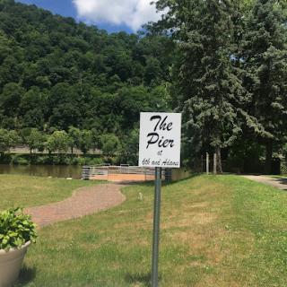 A serene spot by the water, marked by a sign indicating 'The Pier'.
