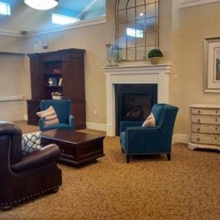 Cozy living room with seating area and fireplace.